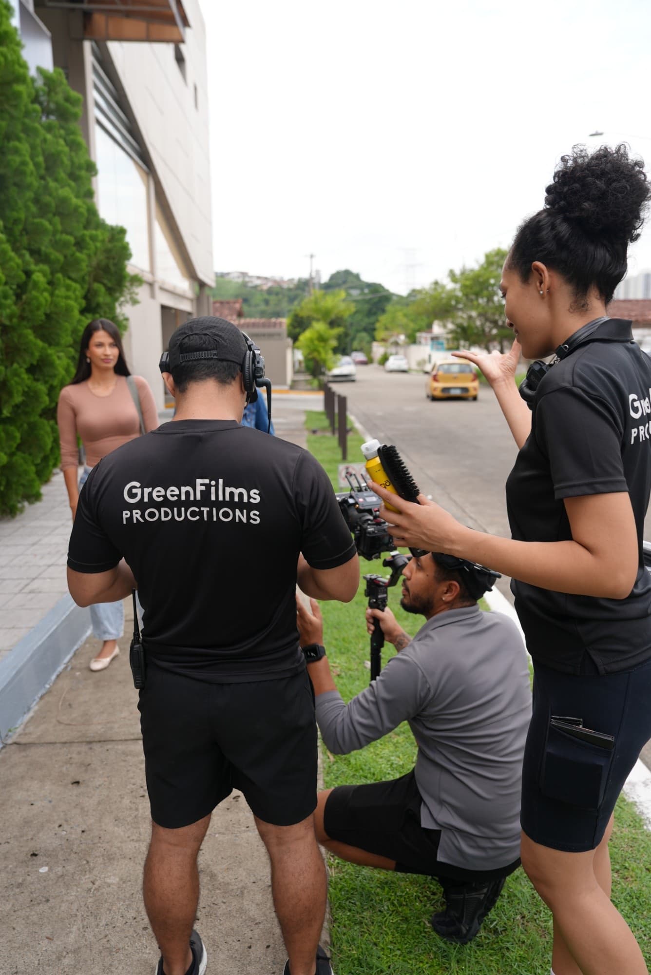 Green Films Productions crew setting up an outdoor shot: camera operator with a gimbal, makeup, and an actress waiting